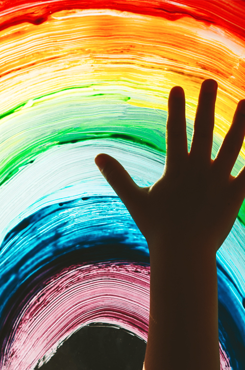 Raised hand and a rainbow