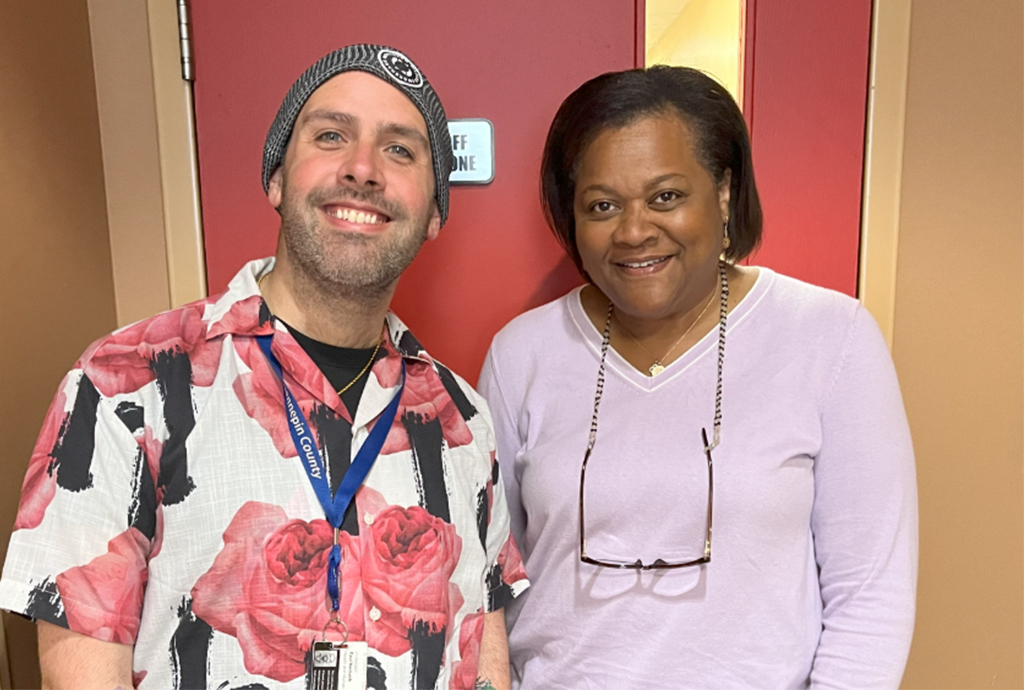 Paul and Pam in front of the red clinic door. 
