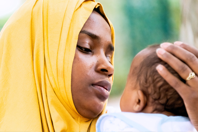 East African woman holding a baby