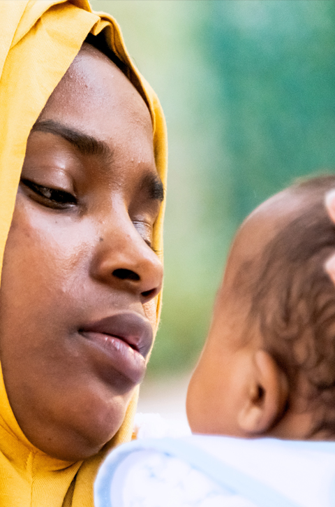 East African woman holding a baby