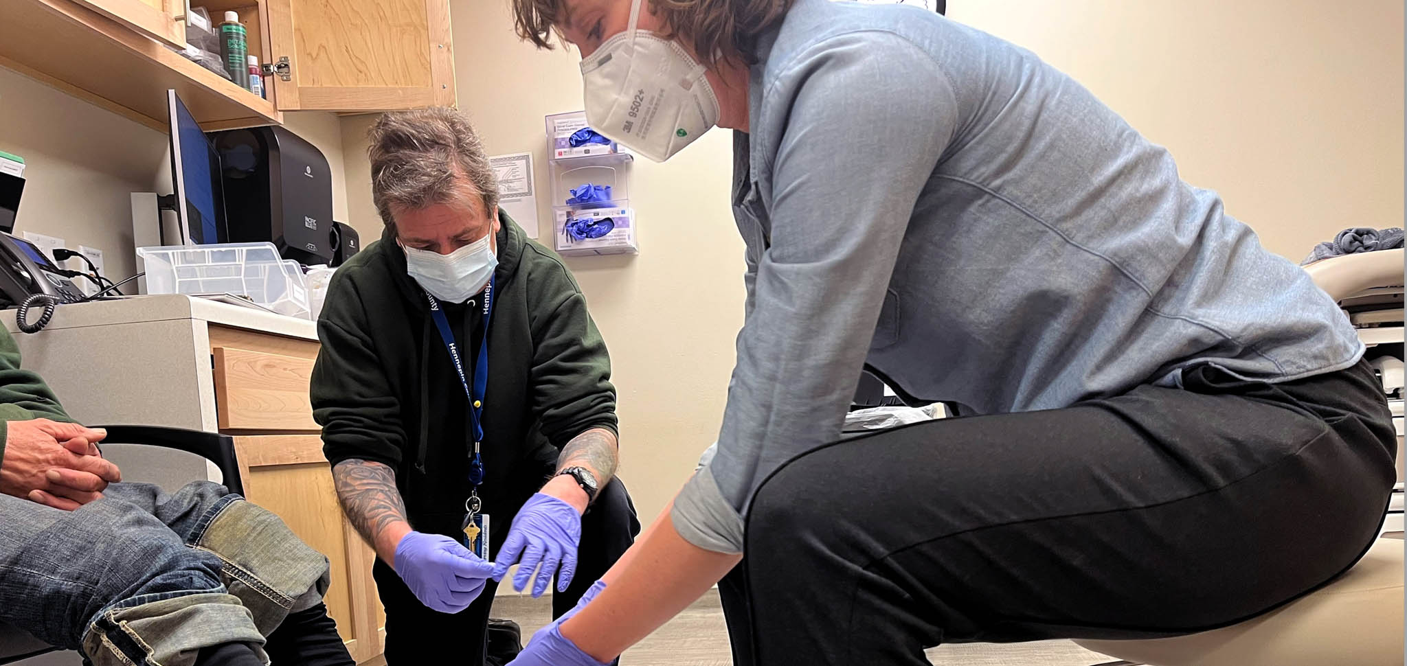 Medical staff bandage a man's feet