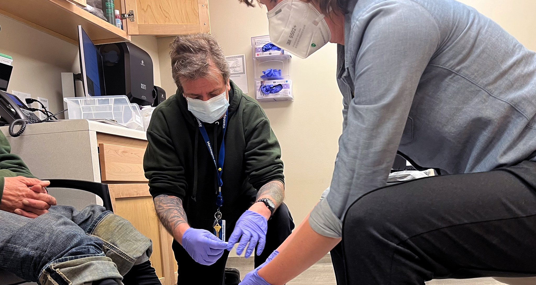 health care providers wrap a man's feet