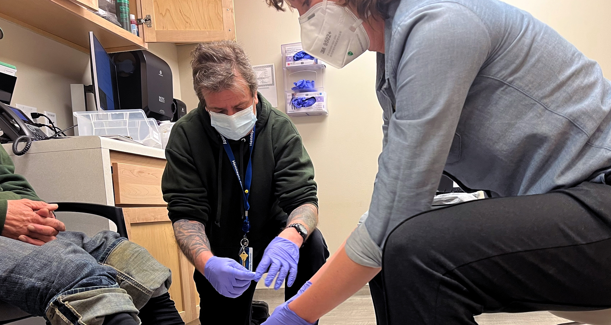 Medical staff bandage a man's feet