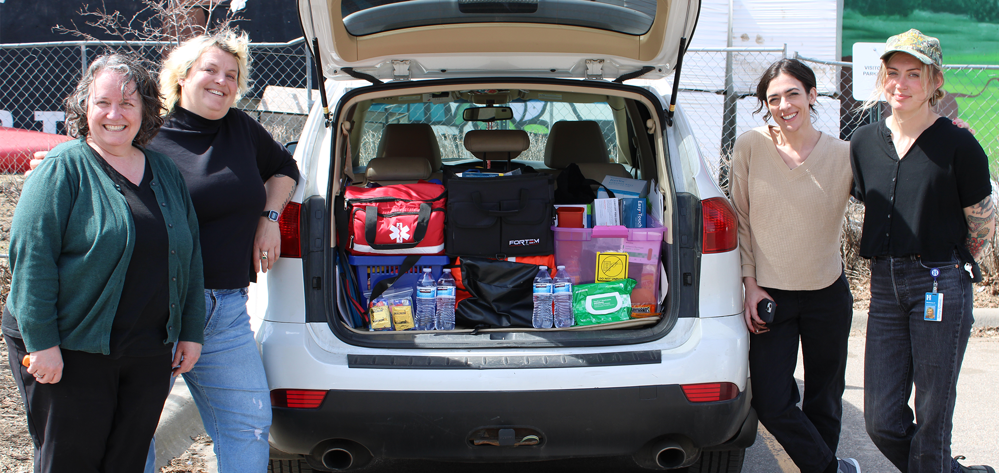 Group photo in front of outreach car