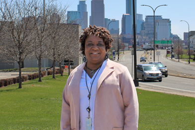 Woman standing in front of Minneapolis skyline. 