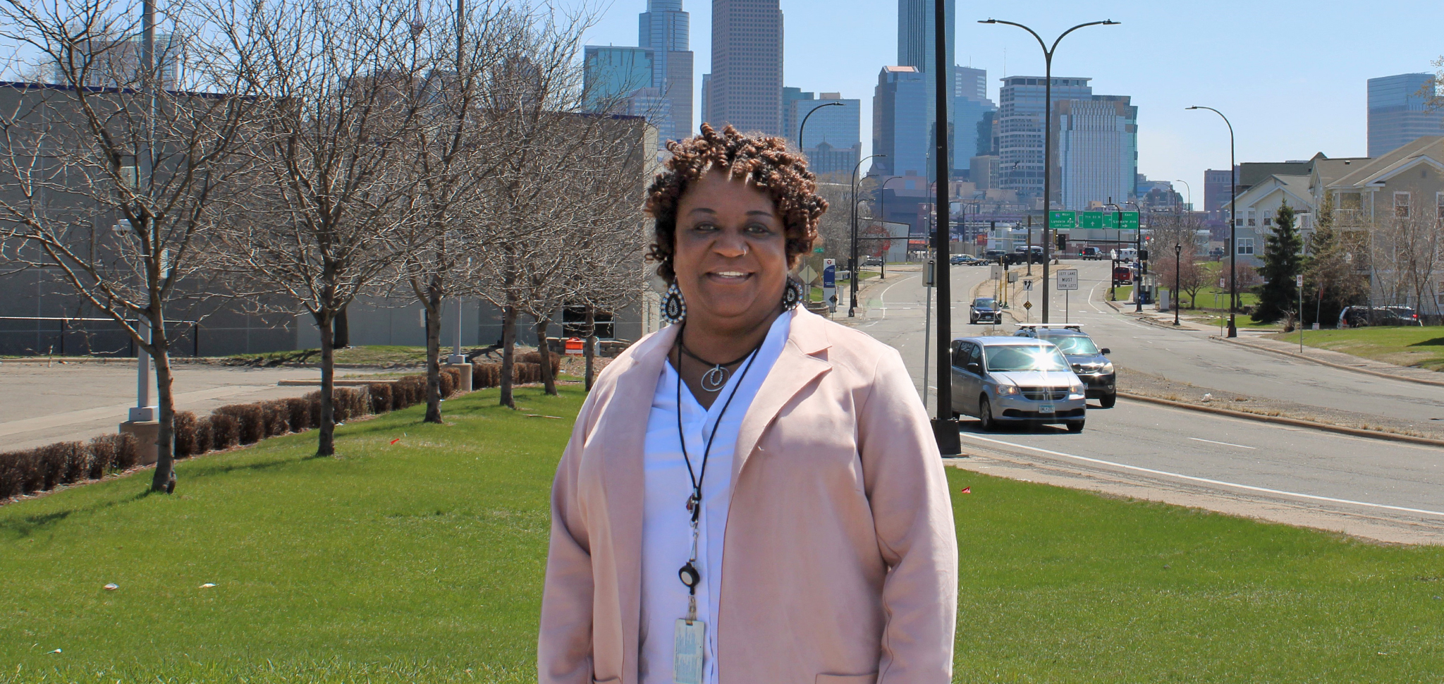 Woman standing in front of Minneapolis skyline. 