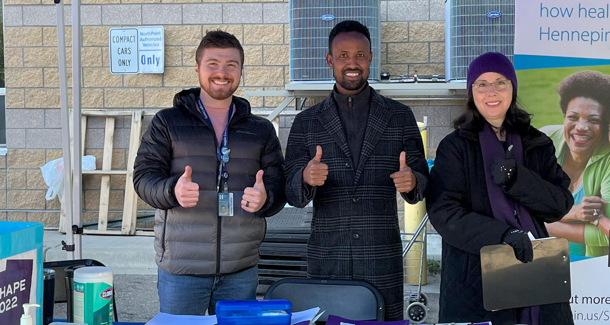 Three people giving thumbs up.