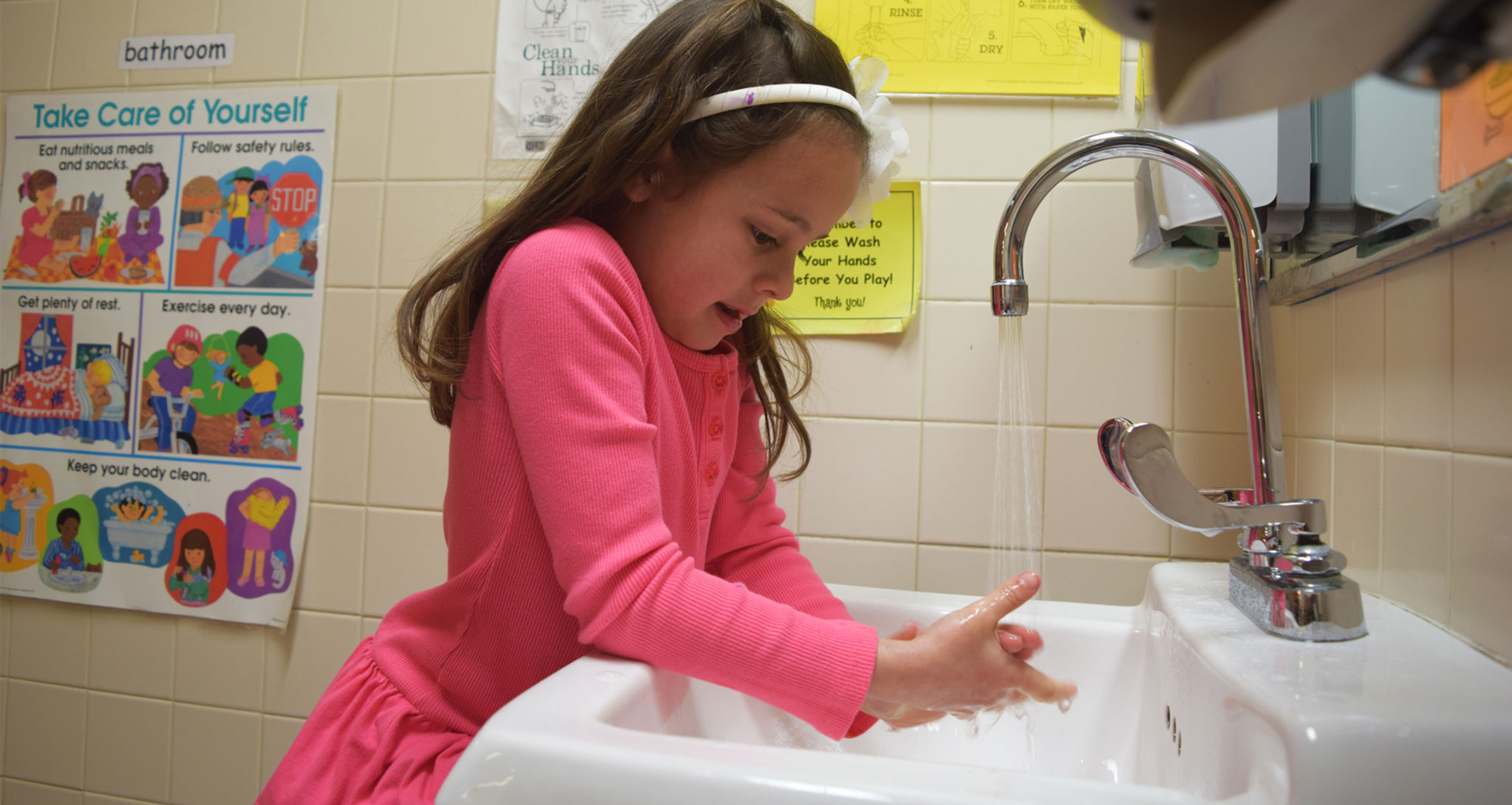 little girl washing her hands