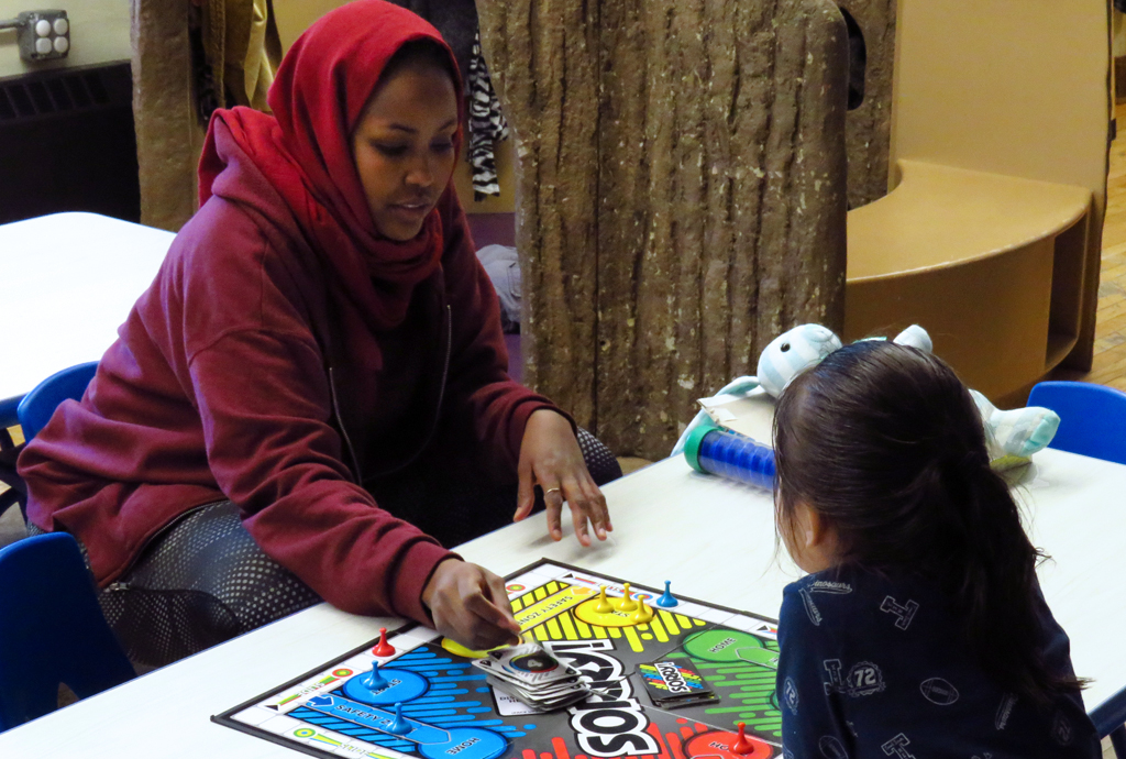 Two people playing a board game at Baby Space