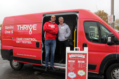 Aliveness Project staff standing in front of mobile van
